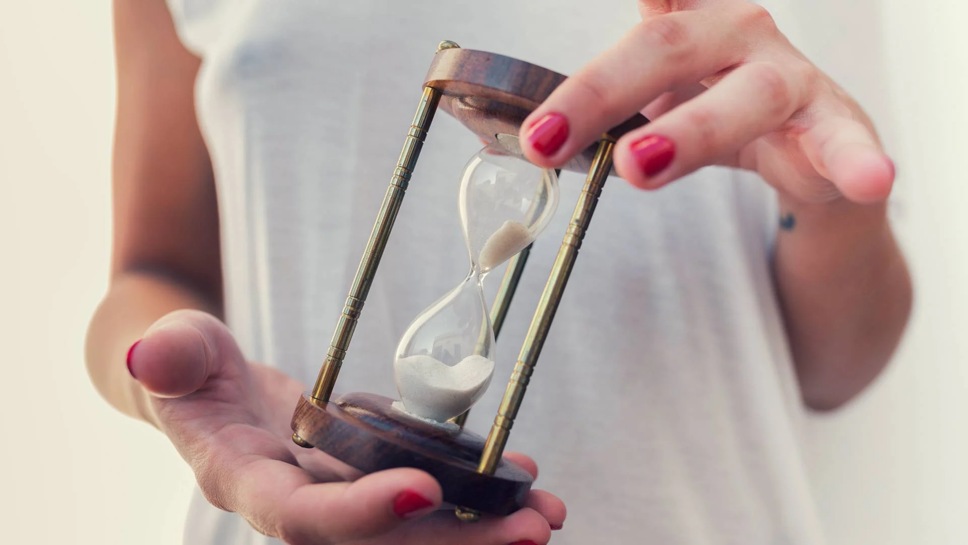 Perosn holding a giant egg timer.