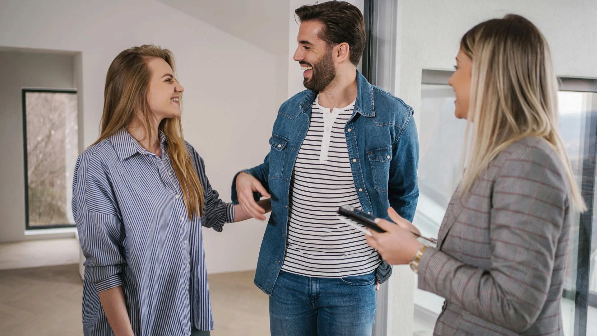 Landlord having a coffee with a tenant in the kitchen of a rental property.