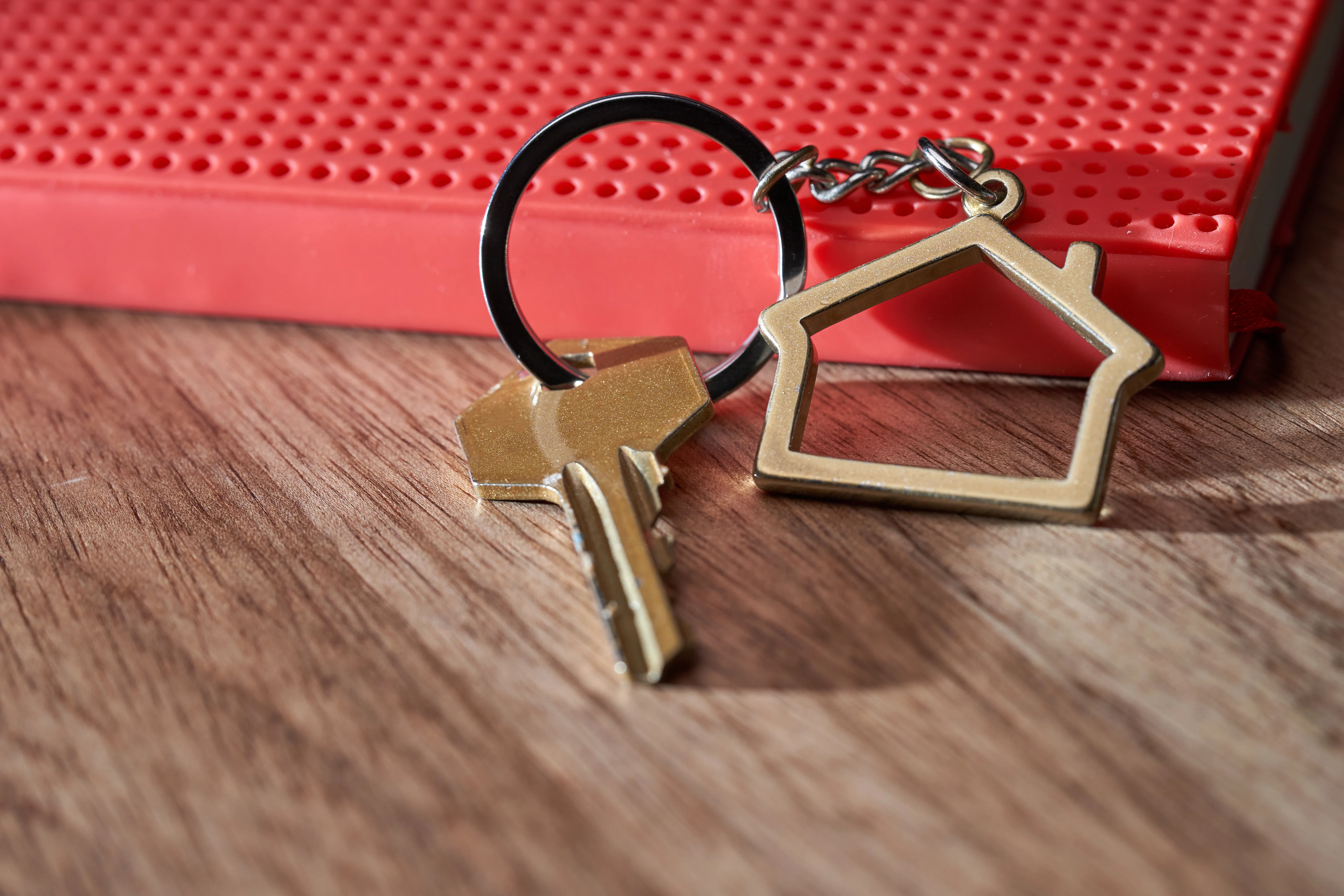 A house key connected to a house keyring.