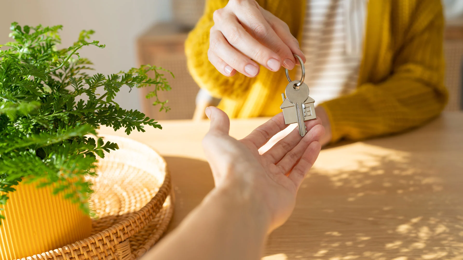 A real estate agent handing over the keys to a property to its new owners.