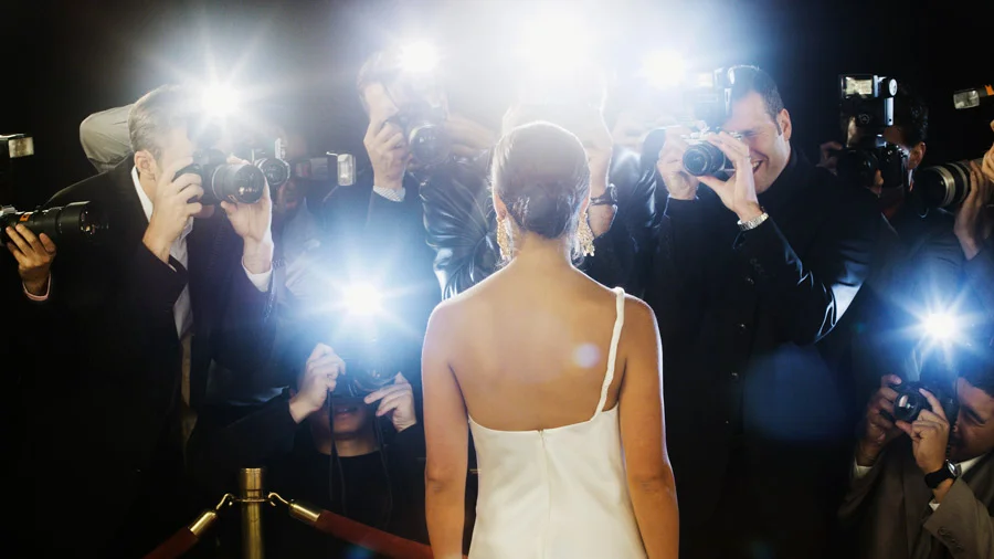 Women in front of paparazzi