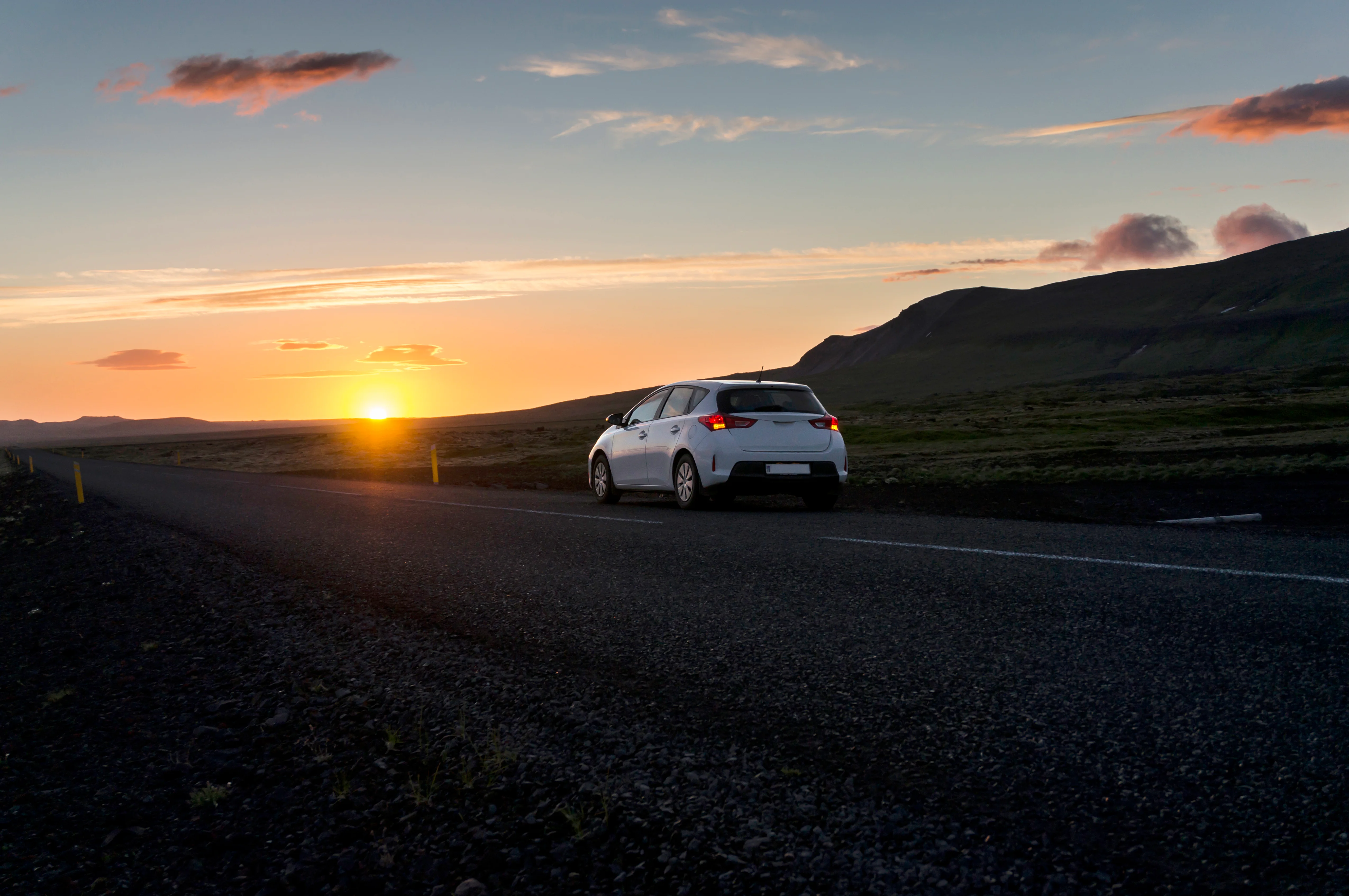 car on road at sunset