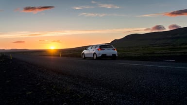 car on road at sunset