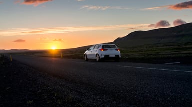 car on road at sunset