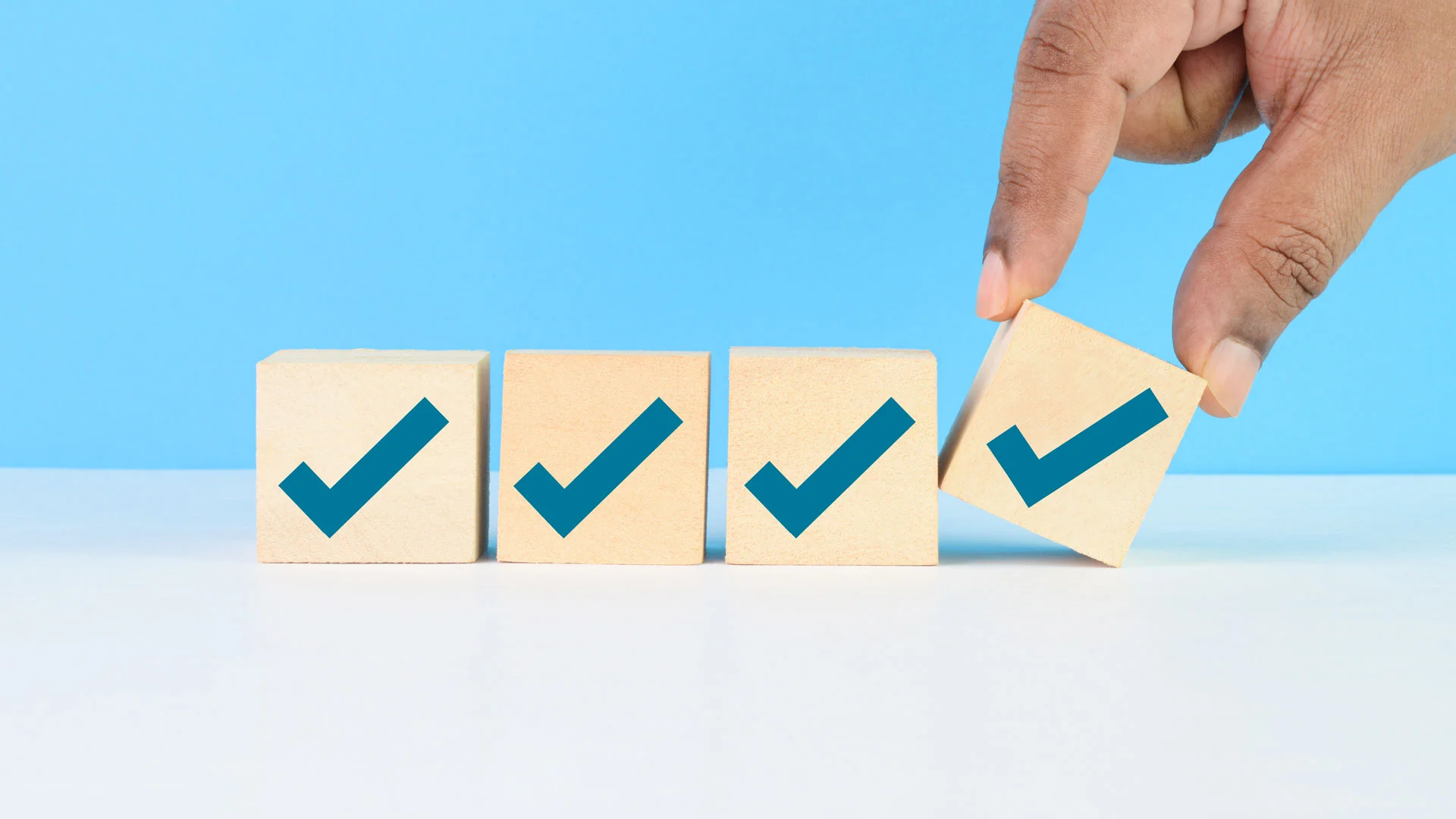 A line of 4 yellow tiles with green ticks in them.