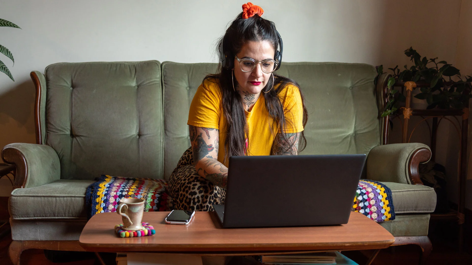 Woman reading about her NZ insurance policy on her laptop at home.