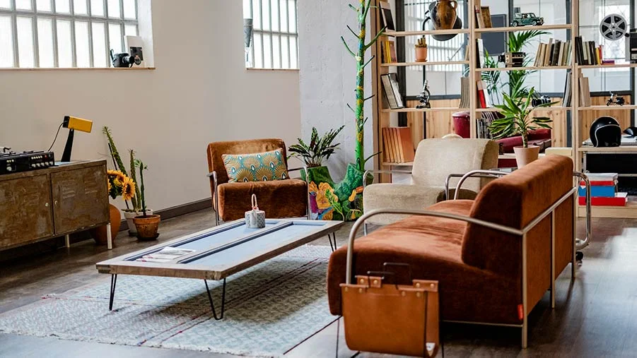 Brown sofa positioned in the middle of a room to help divide it into identifiable sections.