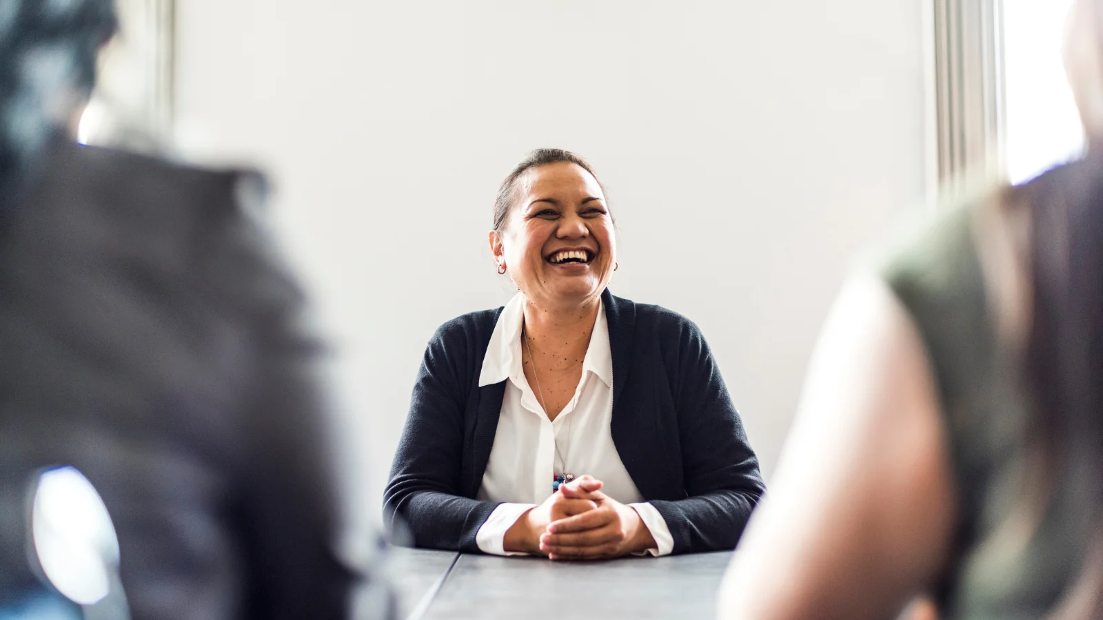 Lady negotiating at table. 