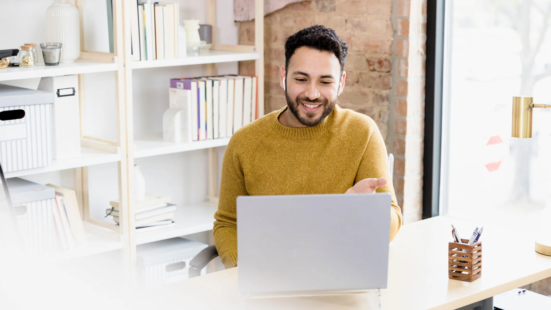 Young male IT employee working online at home.