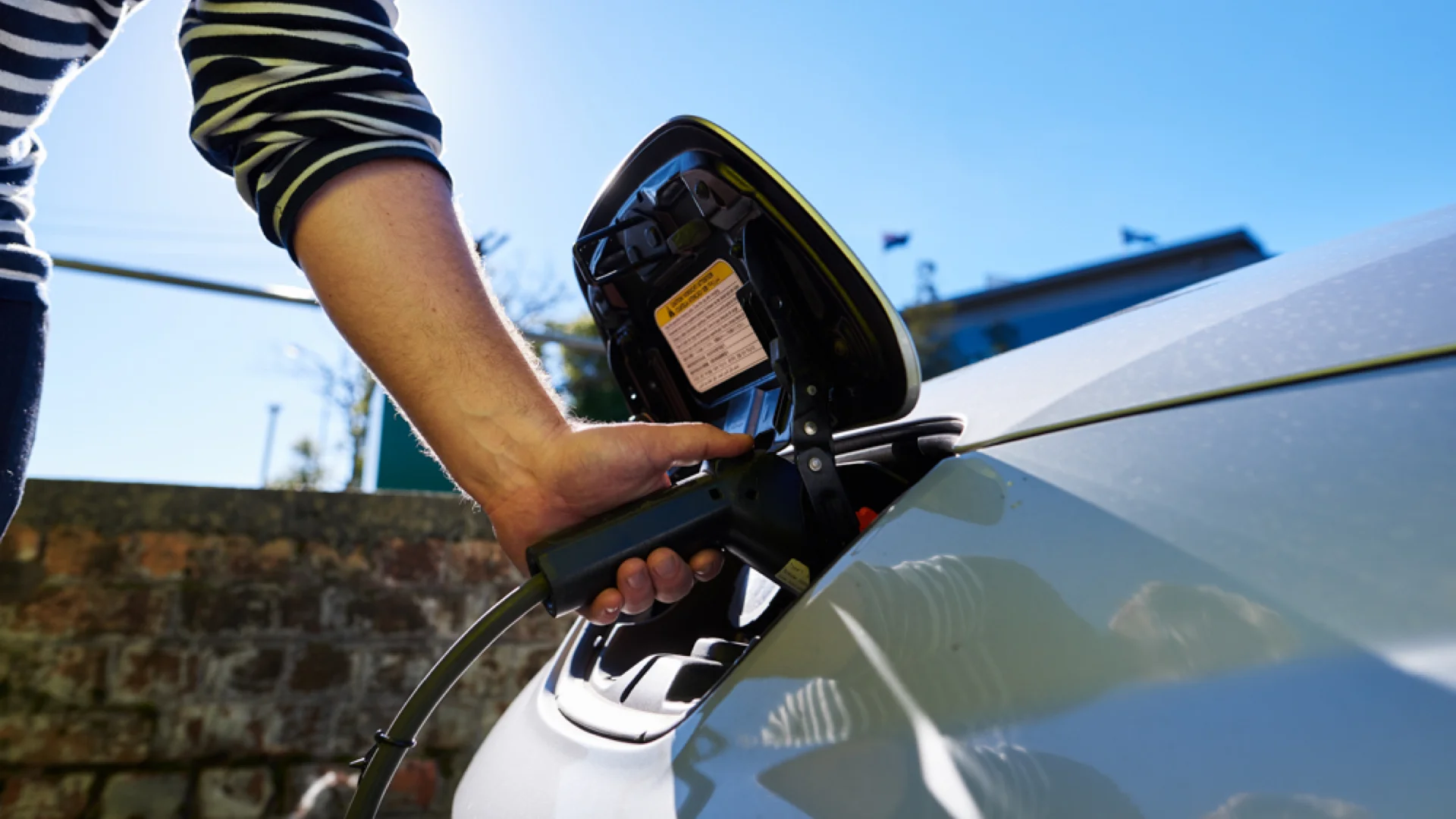 Guy using an EV charger