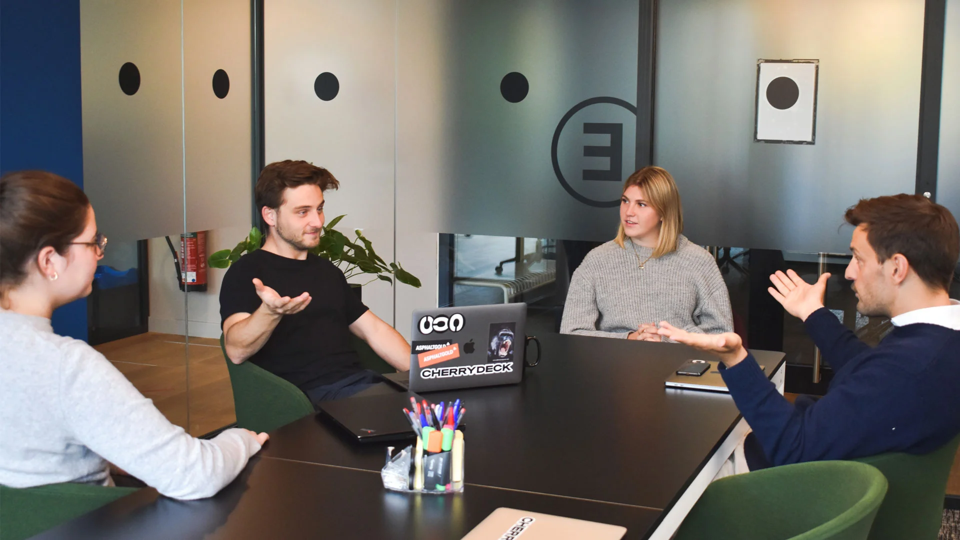 A discussion taking place between candidates at a group interview.