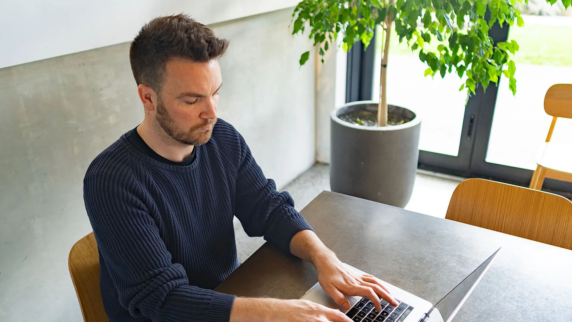 Man sitting a psychometric test at home on his laptop.