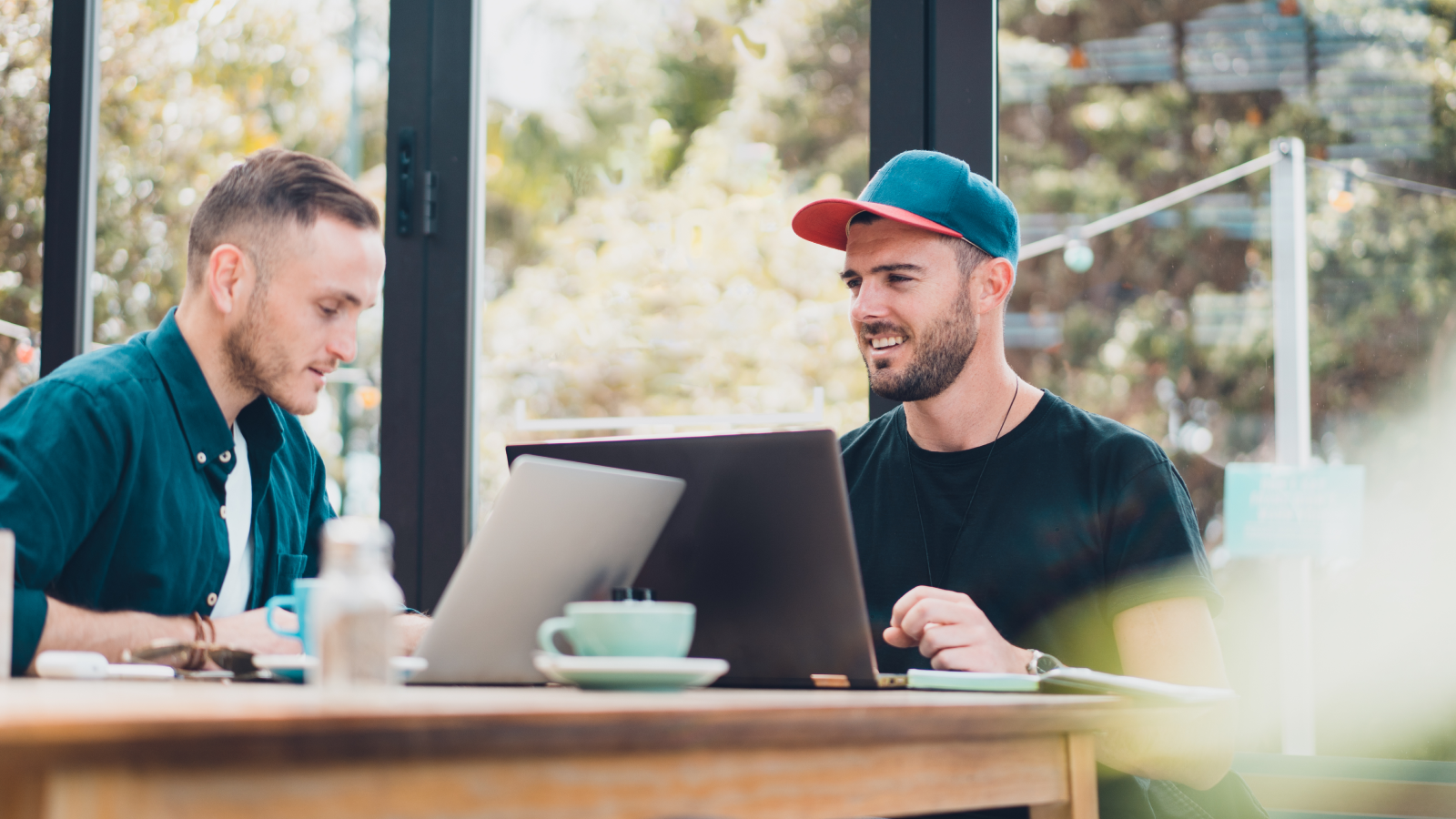 Two co-workers working over coffee