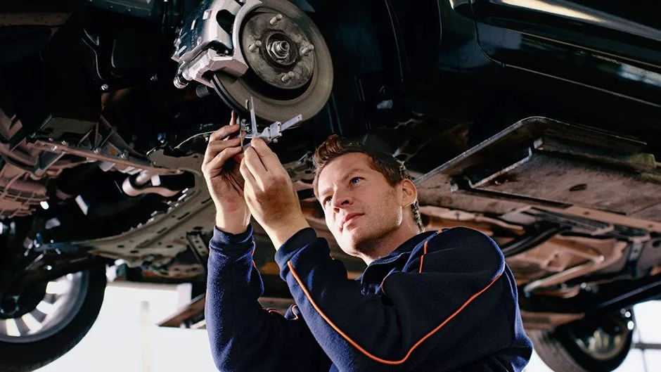 mechanic checking car
