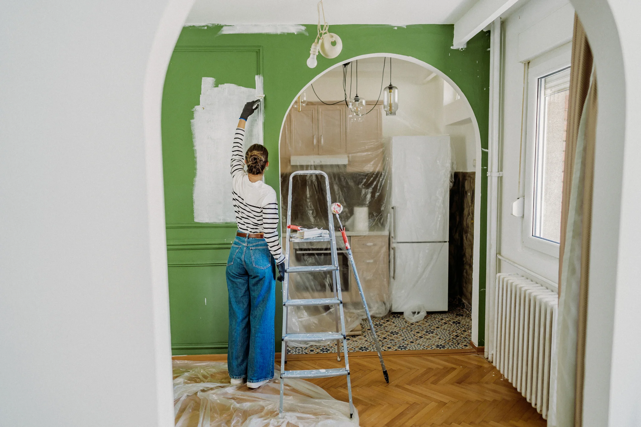 Woman painting entranceway