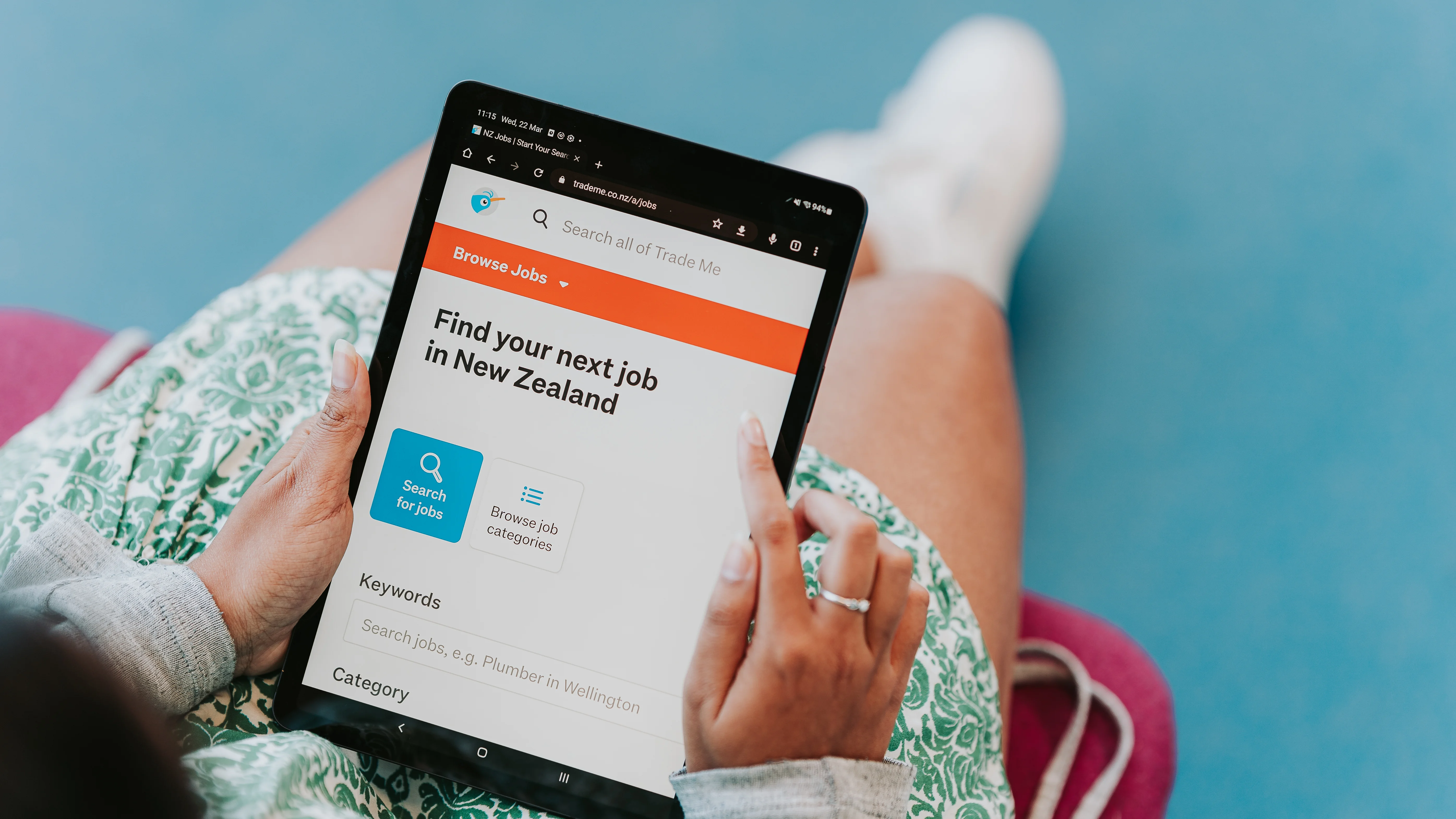 Holding a tablet device with Trade Me Jobs open