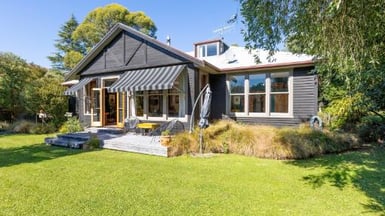 A character-filled former hospital in Little River, blending rich history with warmth, space, and creative charm.