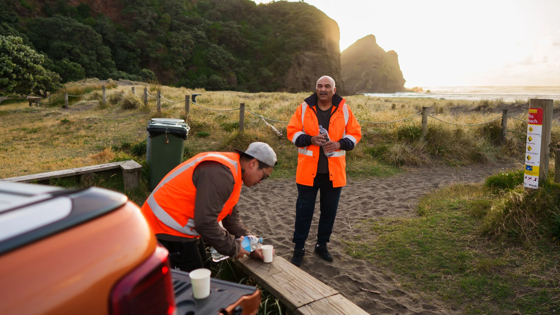 Conservation workers taking a coffee break while working near a beach in New Zealand.