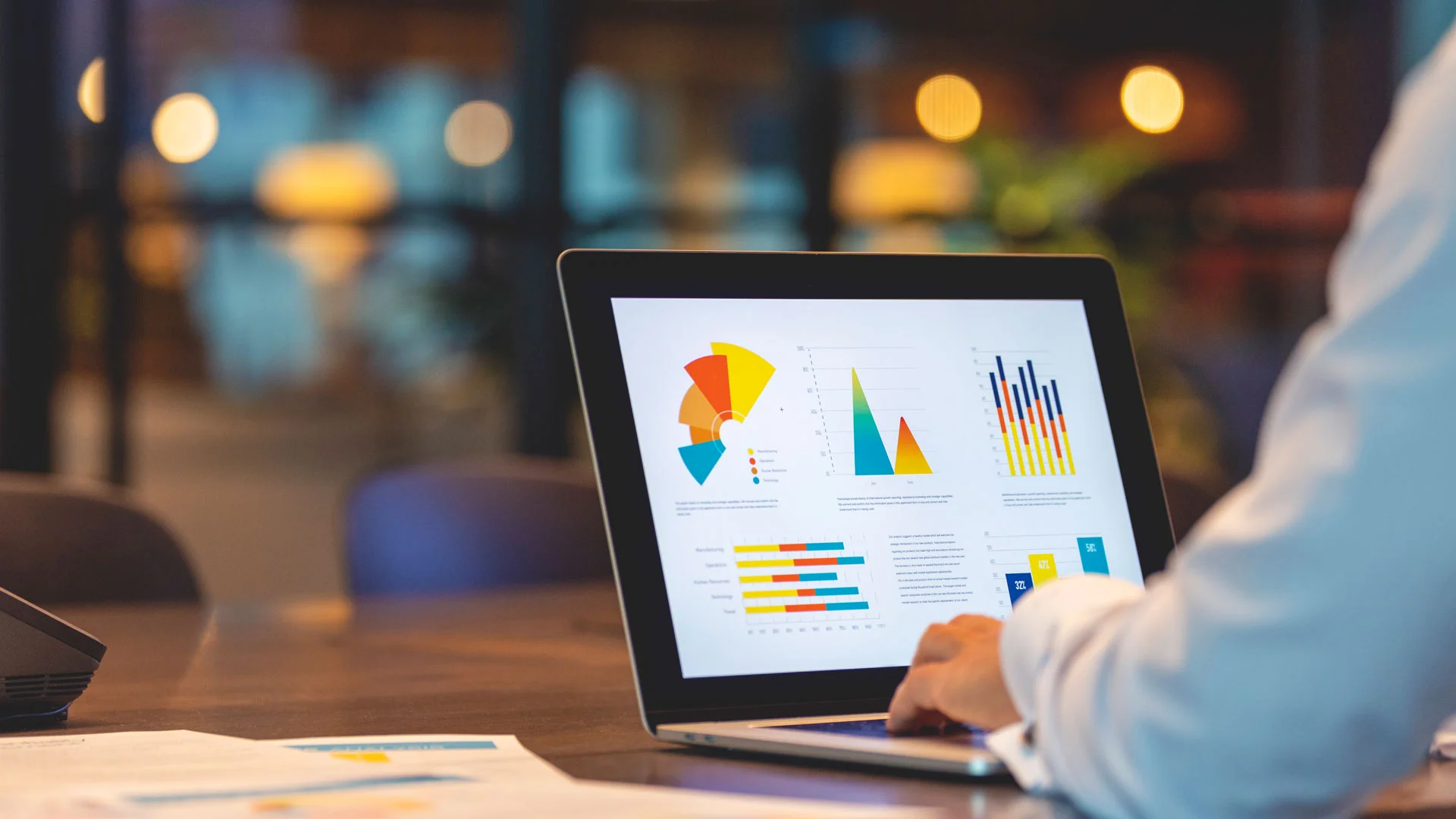 Marketing specialist tracking campaign results on a laptop.