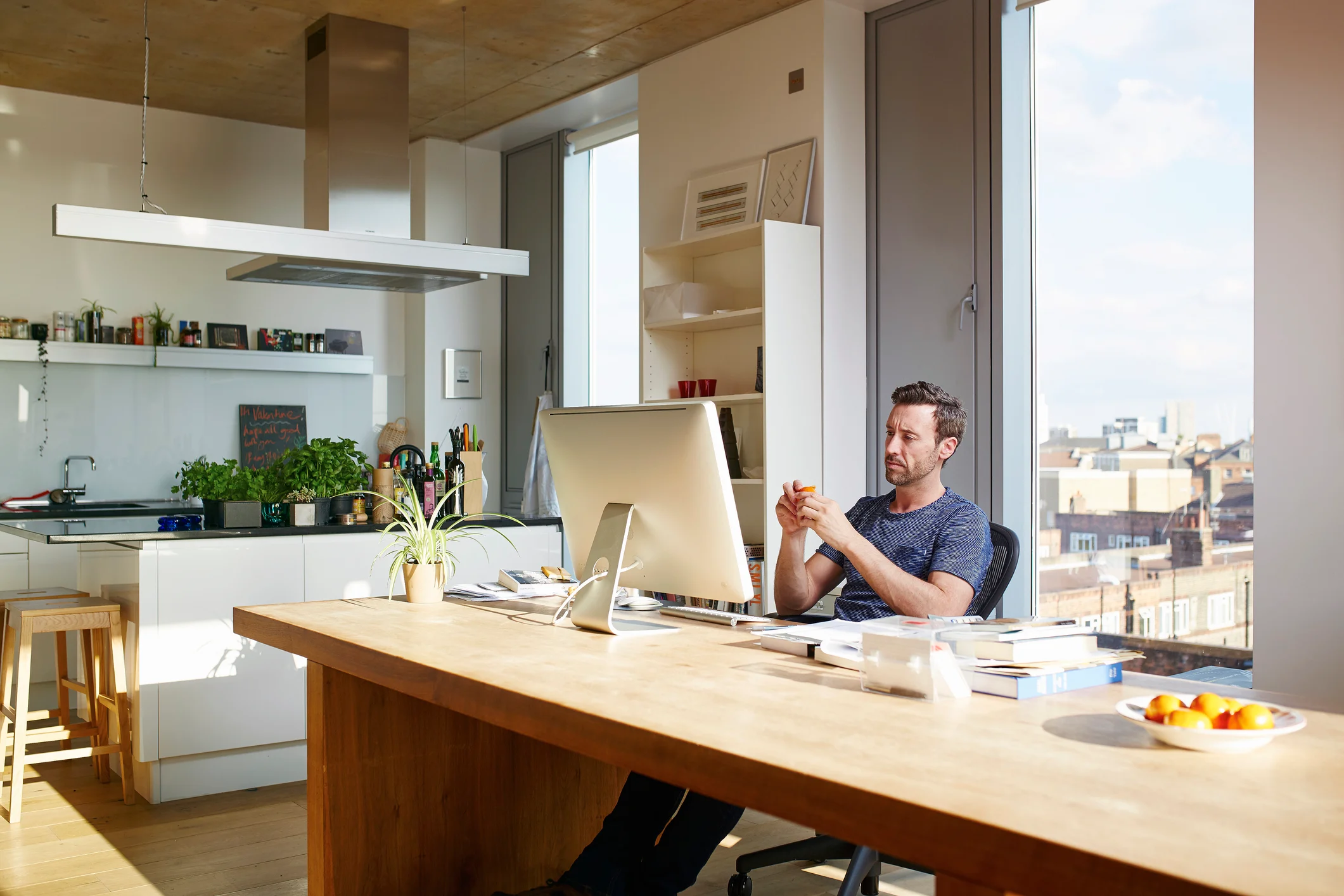 Man sitting at his dining room table with home office set up
