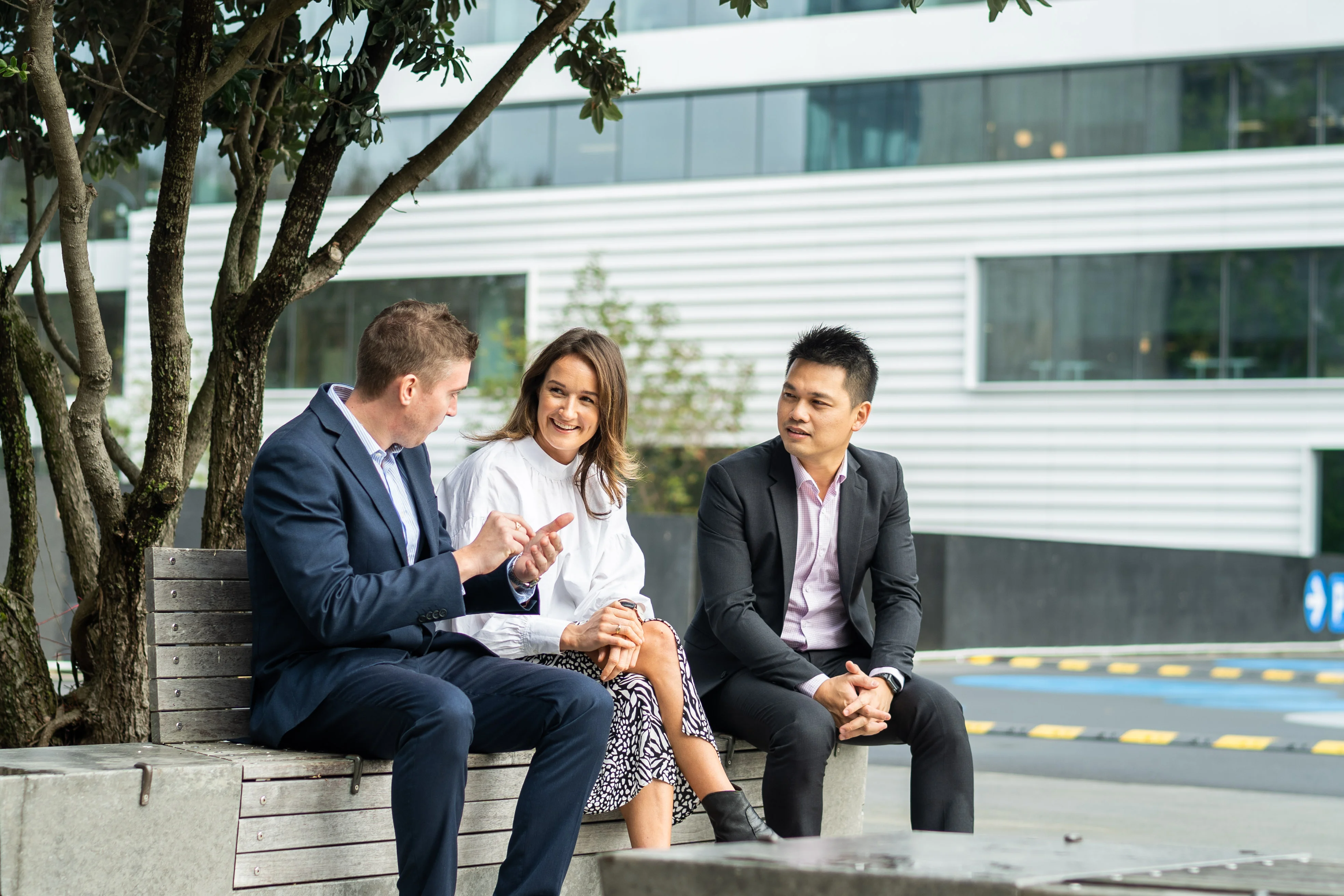 Colleagues chatting on a park bench