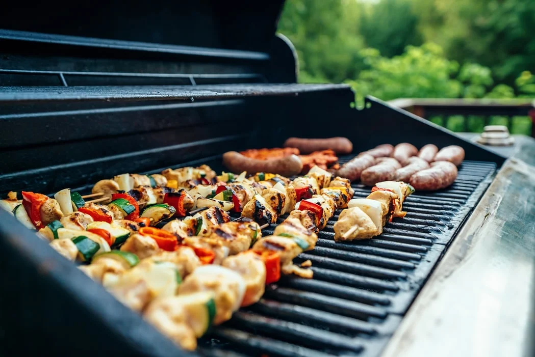 A BBQ grill loaded with food