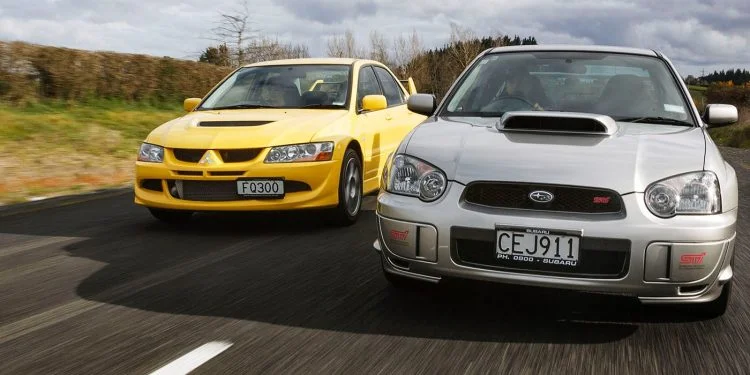 Mitsubishi Evo vs. Subaru WR STi front action