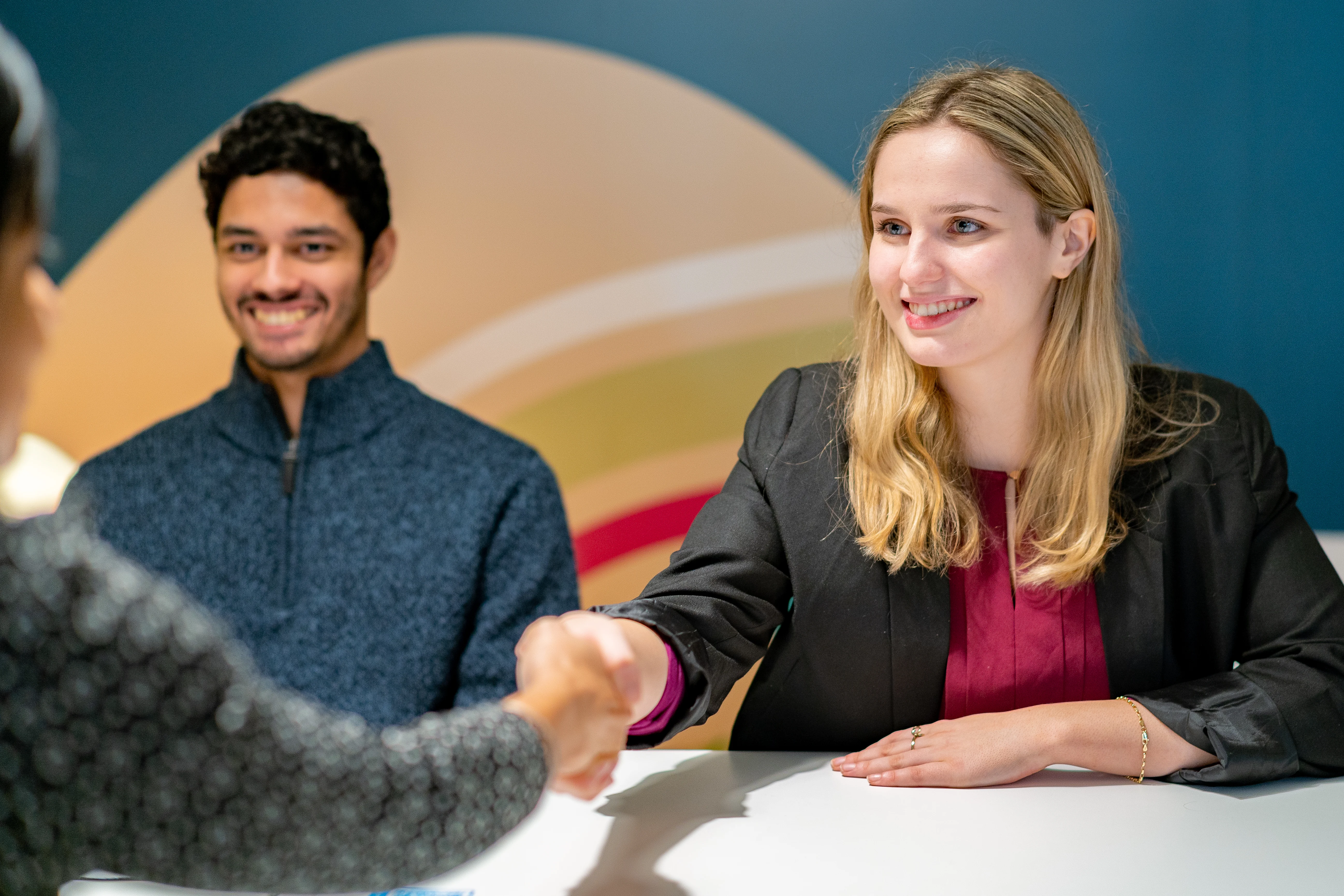 Well dressed women shaking hands.