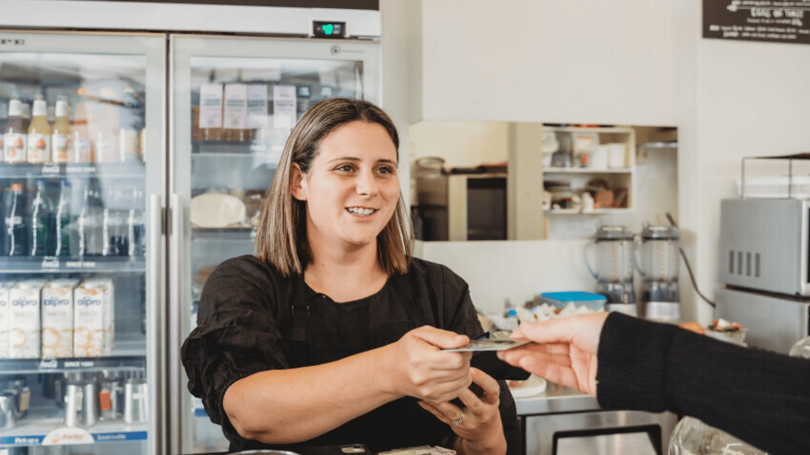 Person handing over their credit card