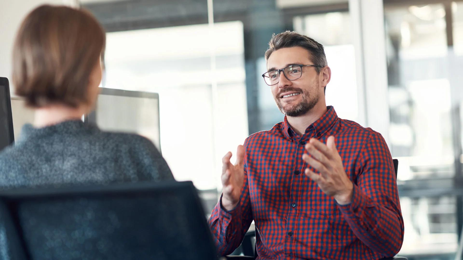 A career mentor coaching his mentee in an office room.