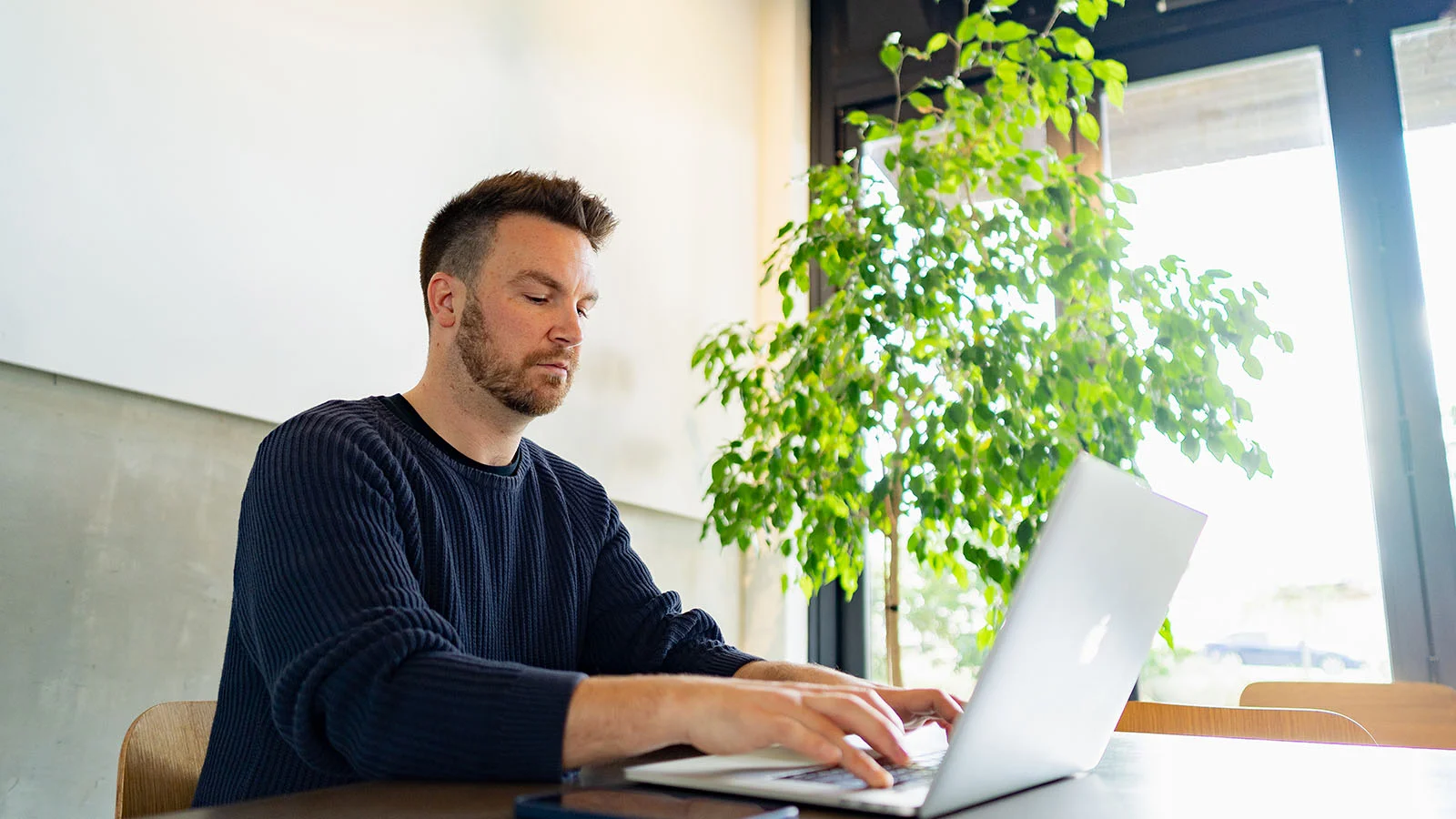 A young person looking inspired when writing the personal statement section of a CV.