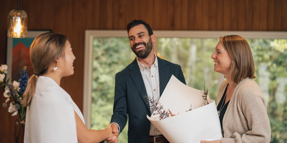 Salesperson shaking hands with a happy vendor