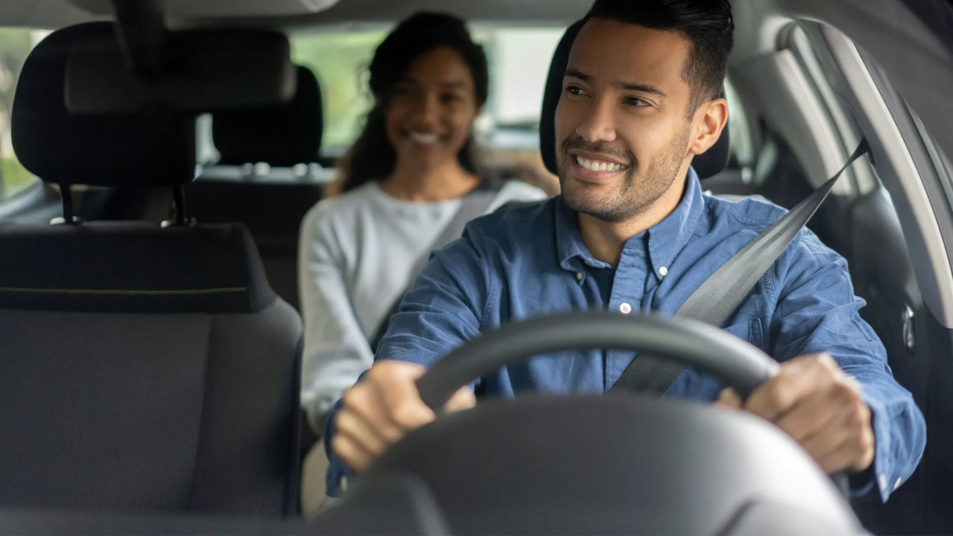Young man working as an Uber driver at the weekend to earn some extra money.