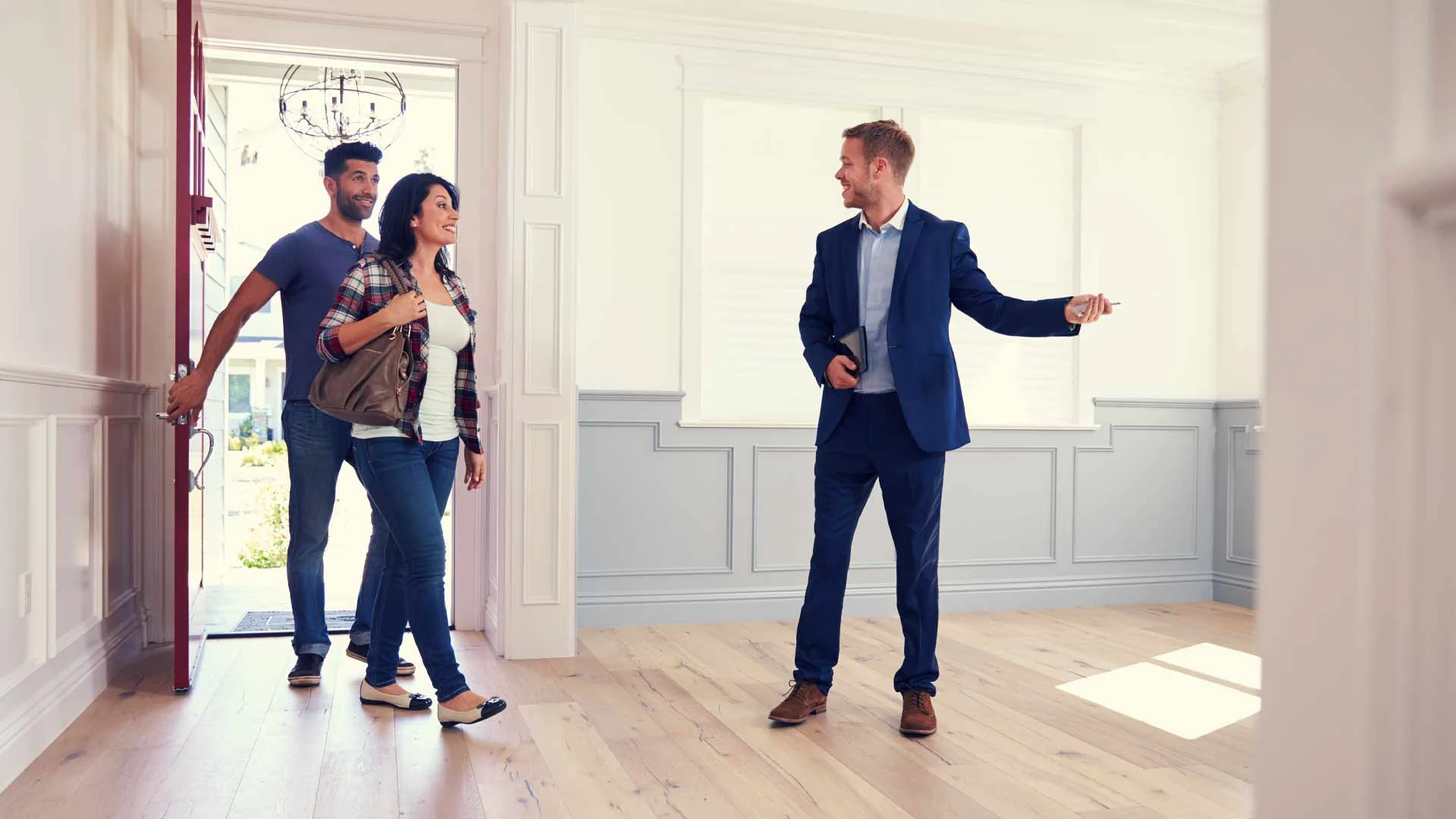 A couple at an open home with a real estate agent 