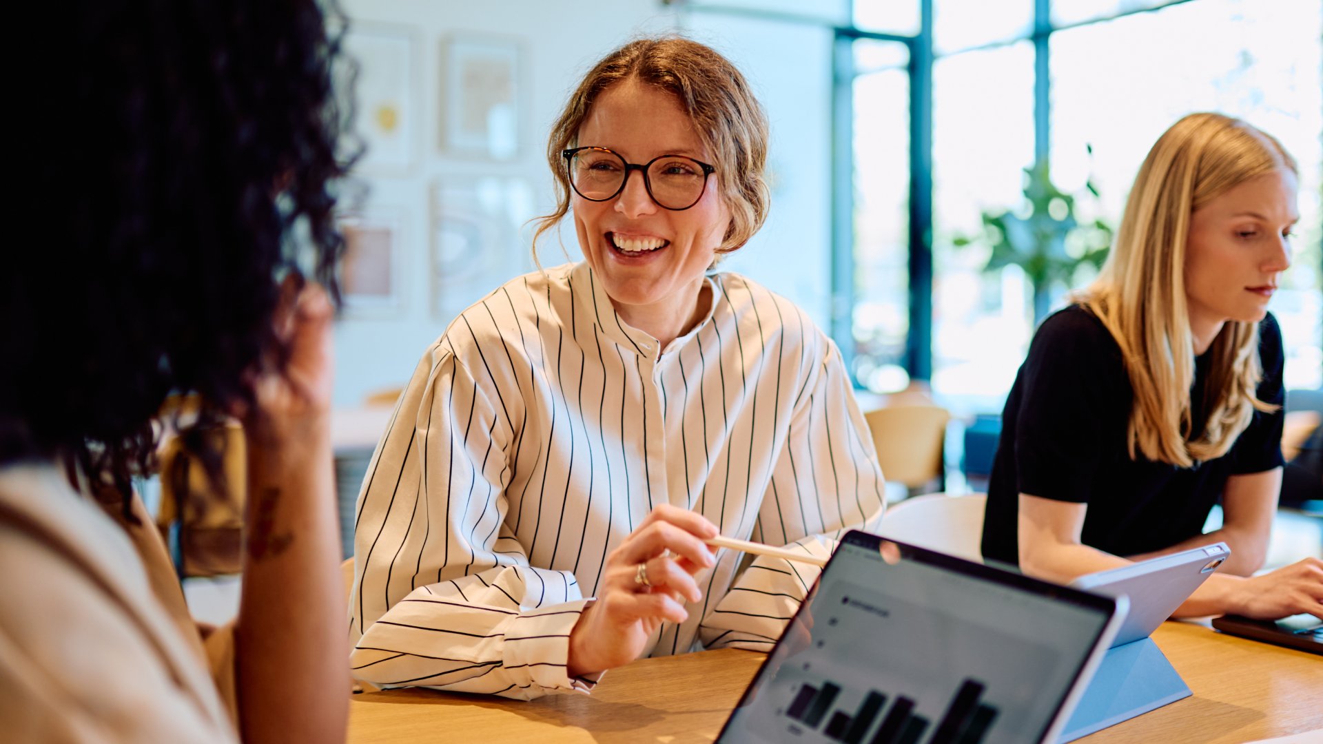 Female project manager with her colleagues in the office