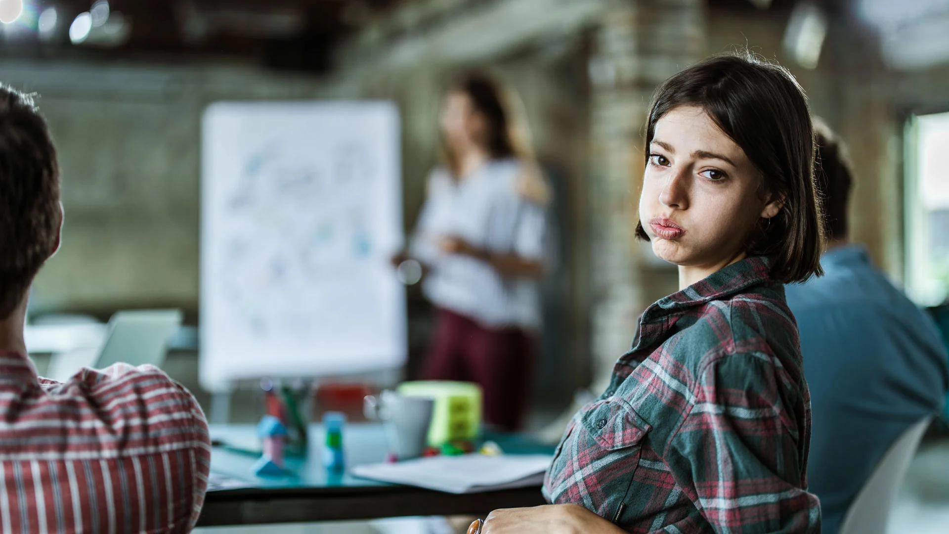 Employee bored in a meeting.