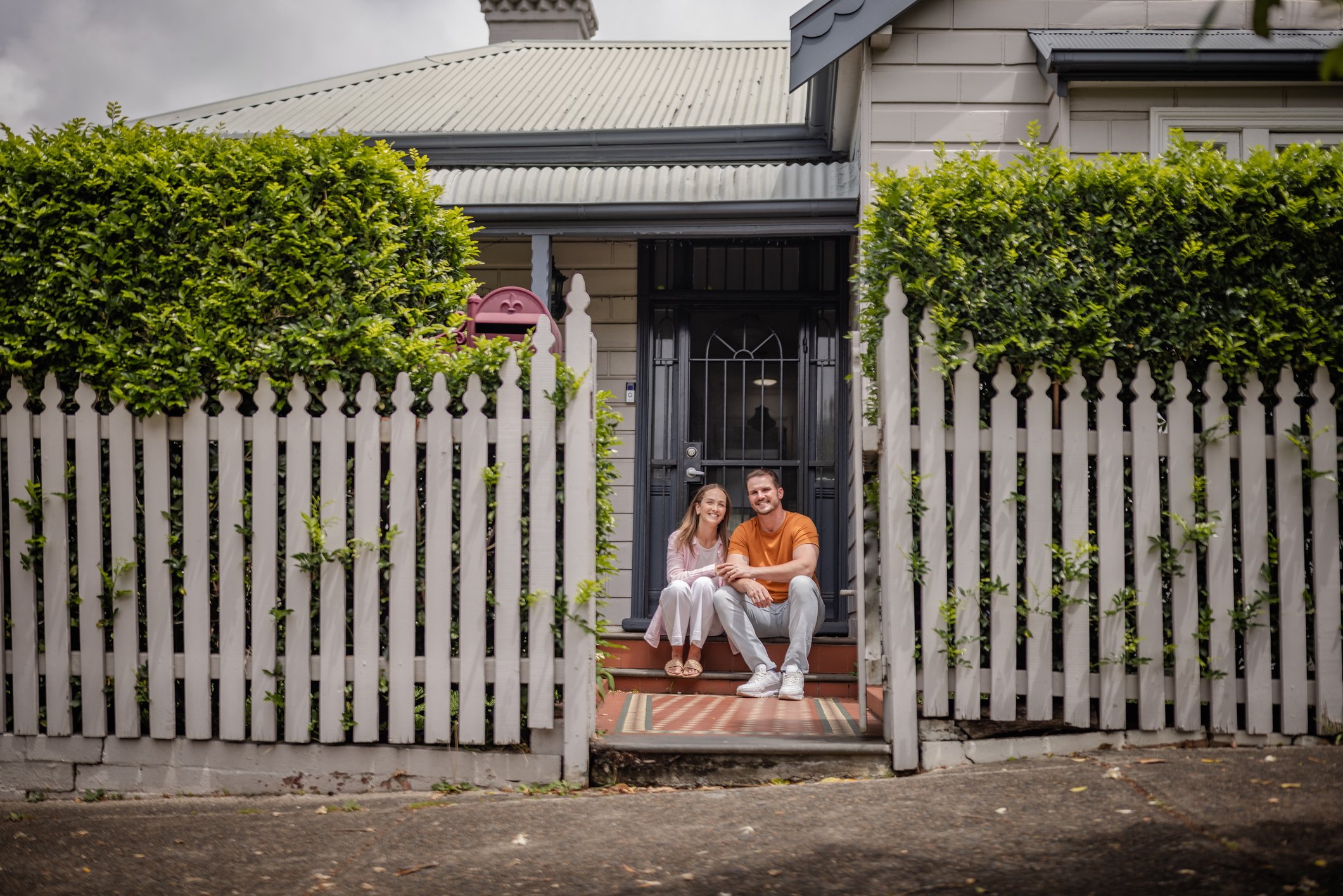 Couple sit on their doorstep
