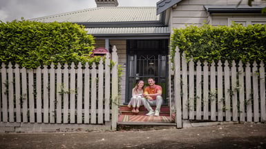 Couple sit on their doorstep