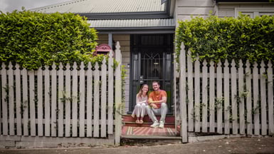 Couple sit on their doorstep