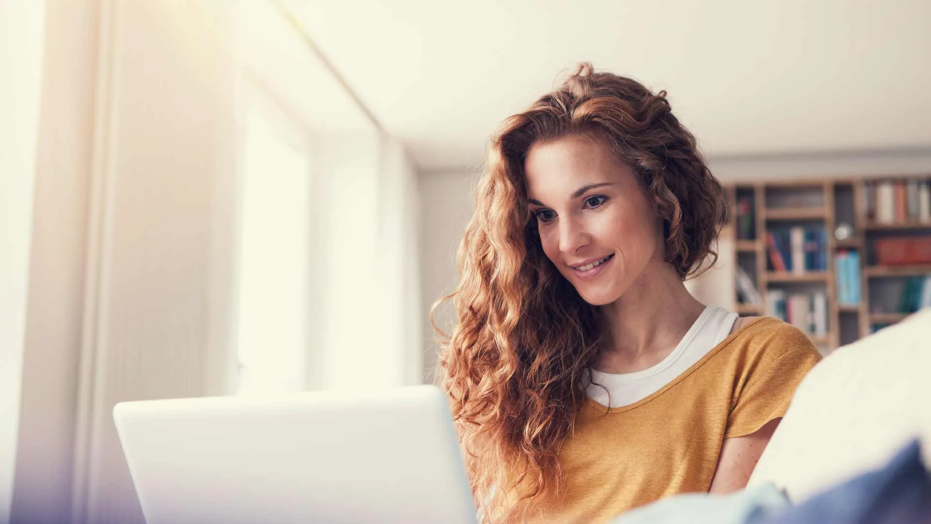 Woman using Trade Me Property insights to find out how much a home is worth.