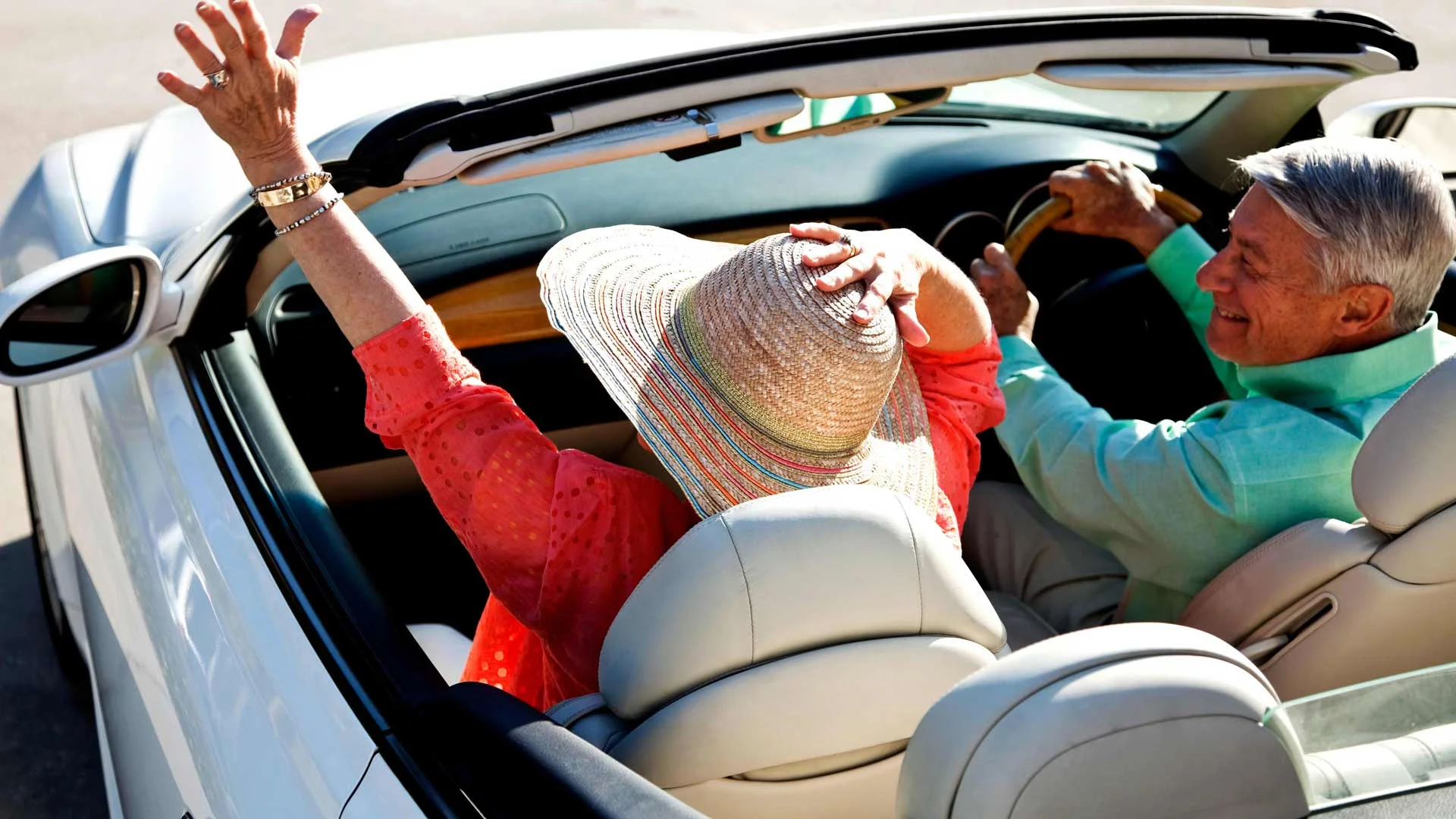 Happy mature couple travelling in car