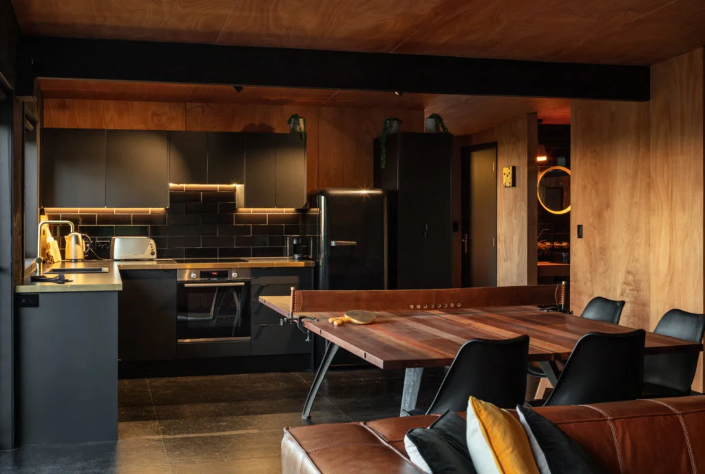 A small kitchen with wooden ping pong table