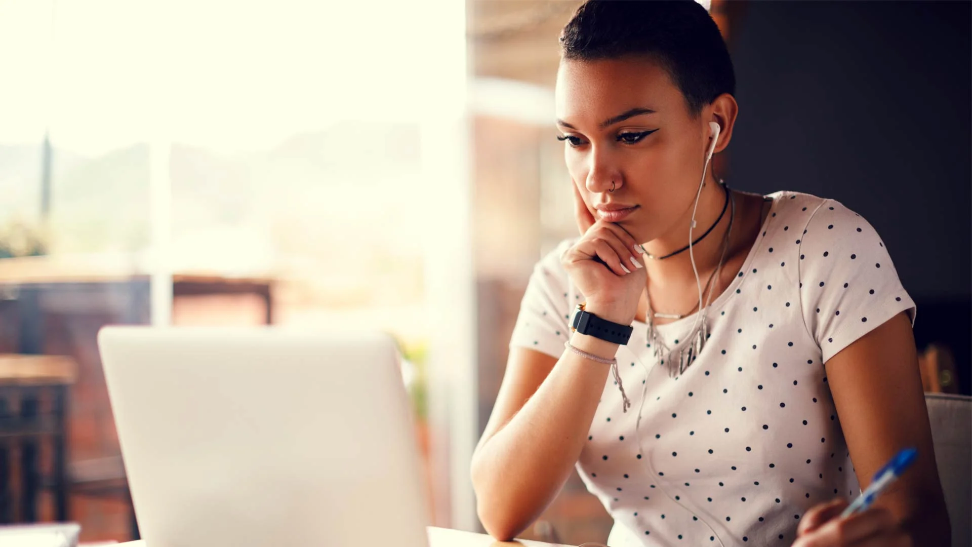 Young candidate reviewing her online presence on a laptop.