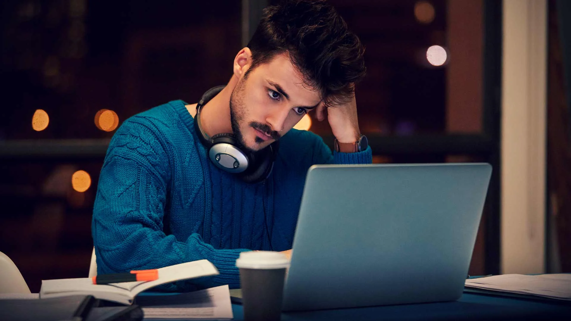 Man bored at his laptop at work.
