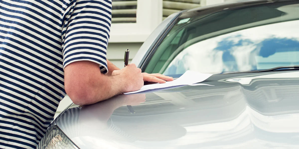 signing receipt car hood