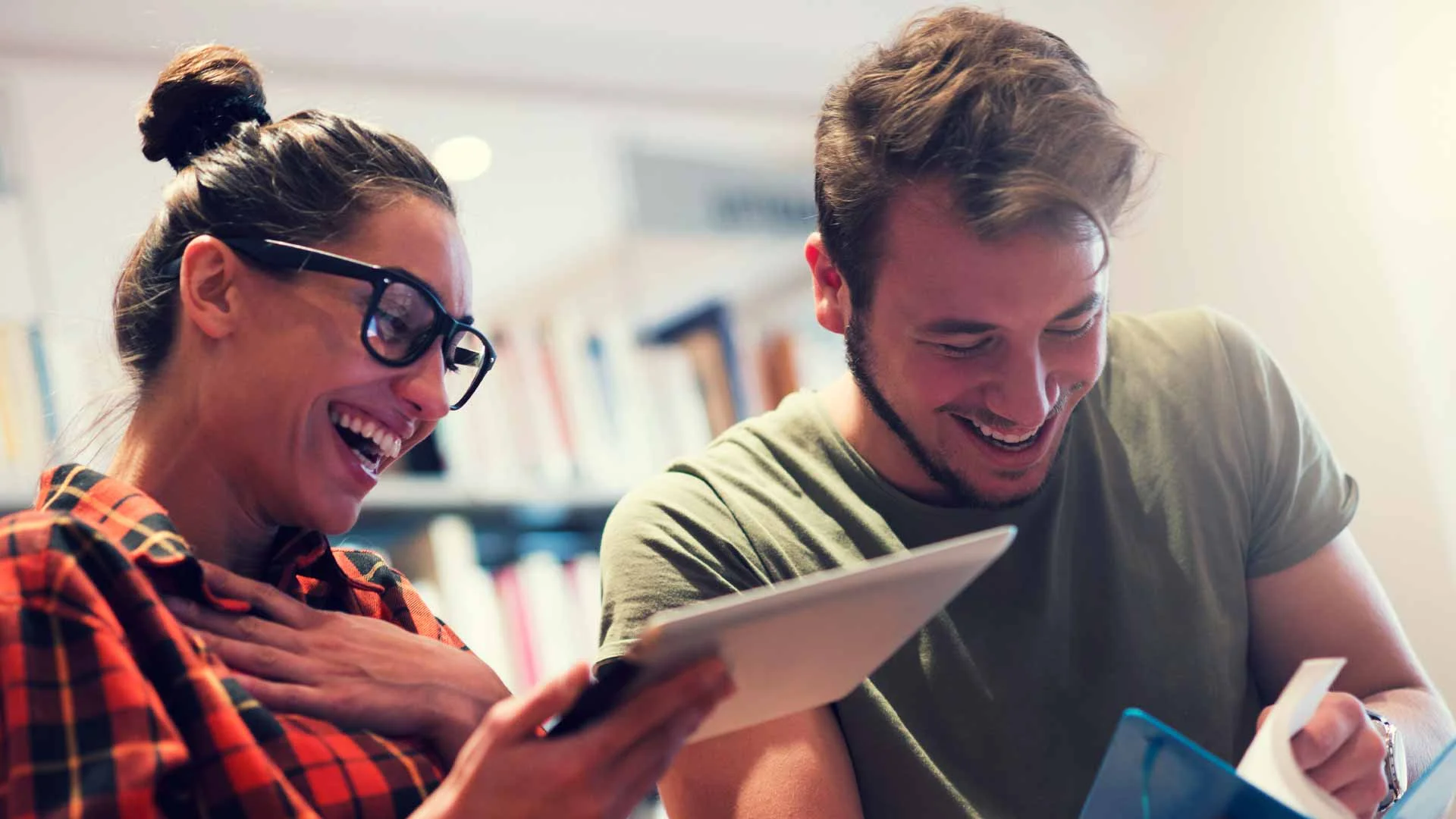 Colleagues laughing together in the office.