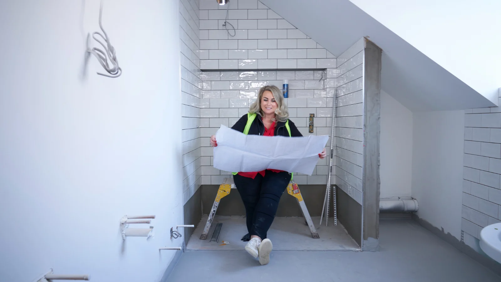 Lady looking at bathroom plans
