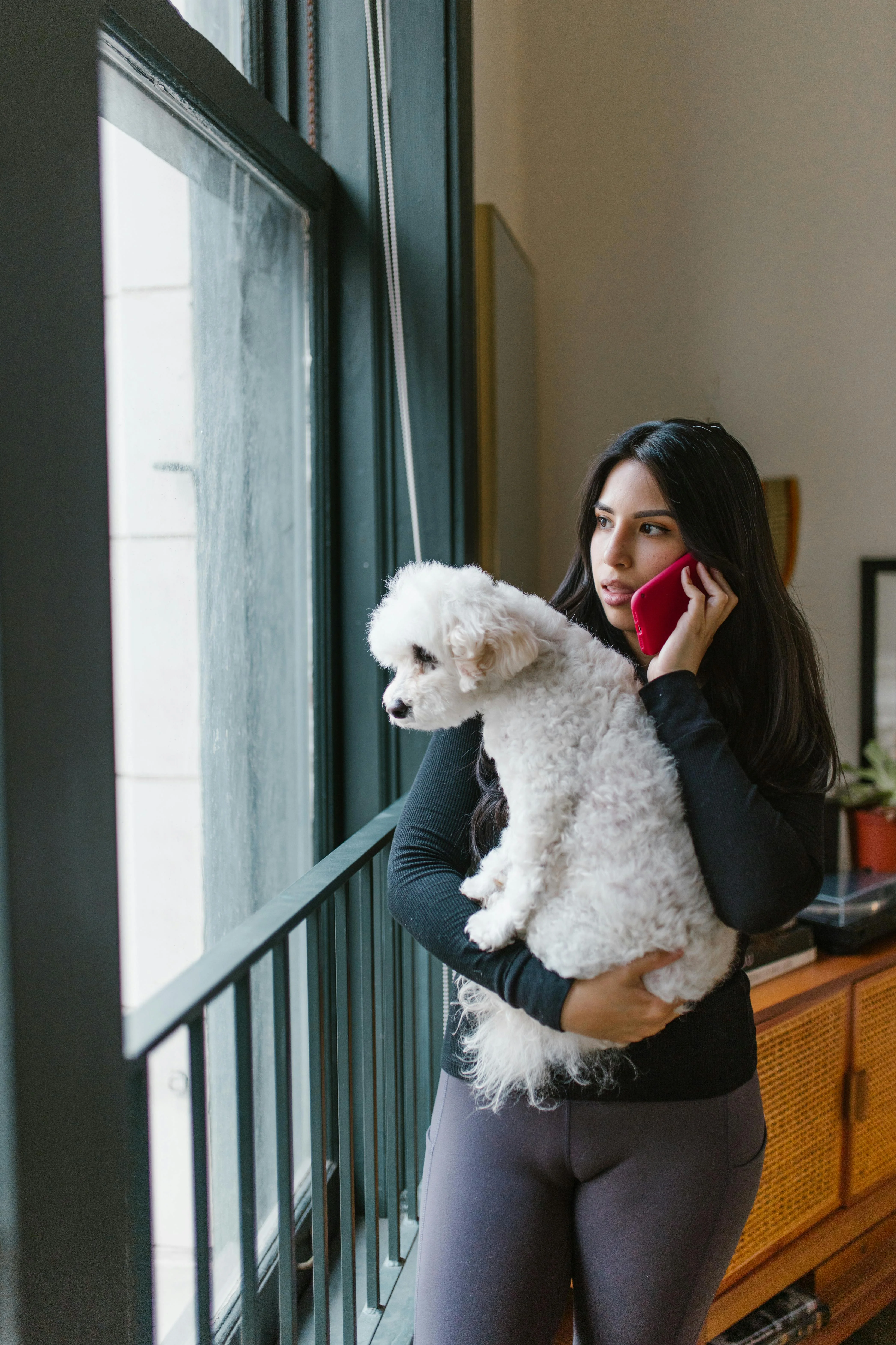 Taking a call with her dog