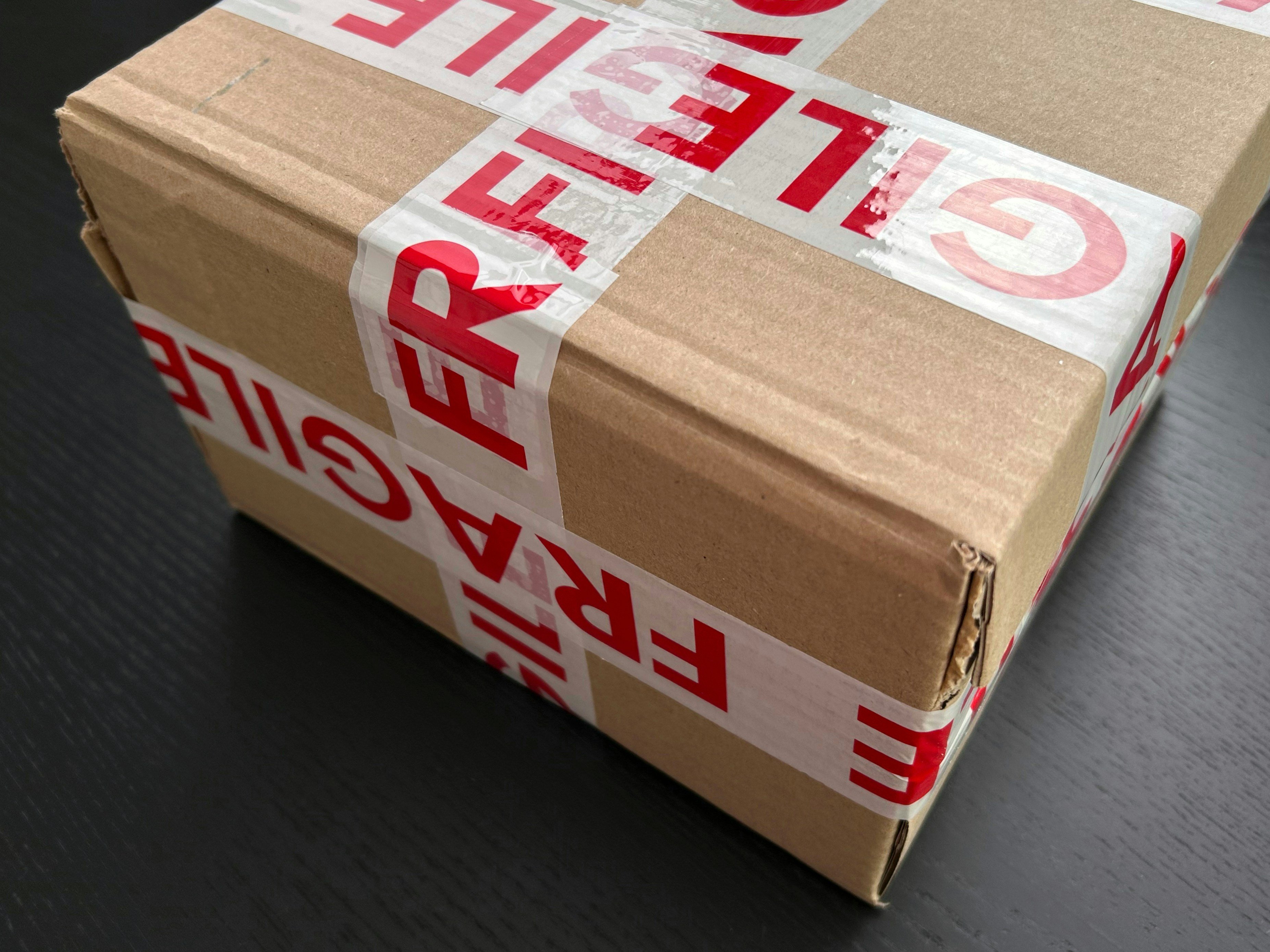 A package wrapped in brown paper and fragile tape.
