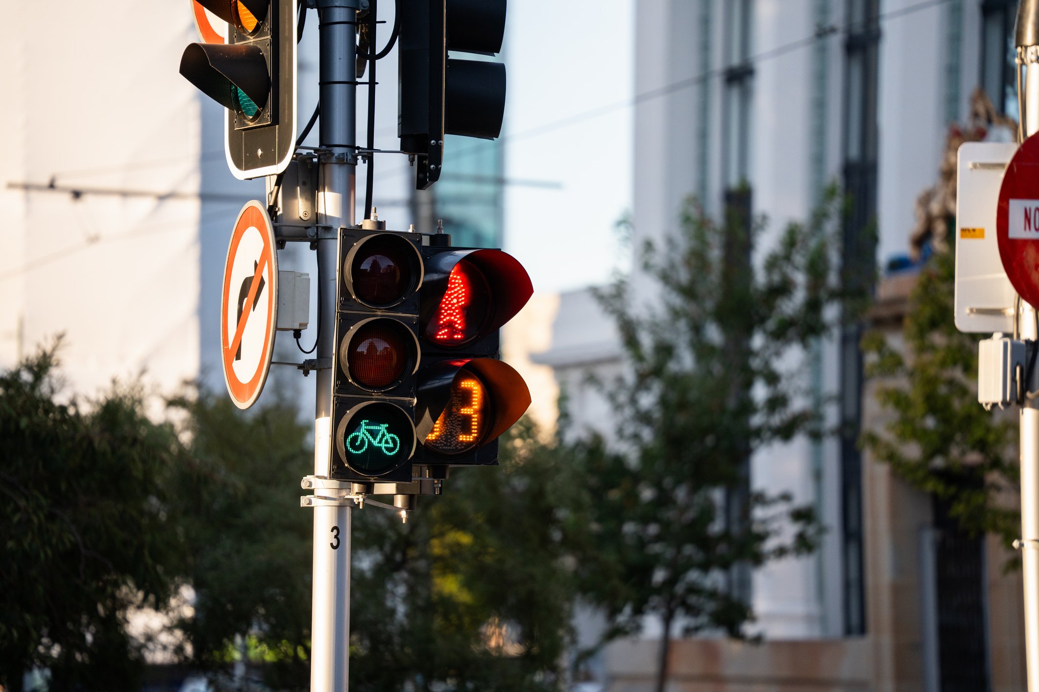 Sidewalk crossing light and green and red traffic light